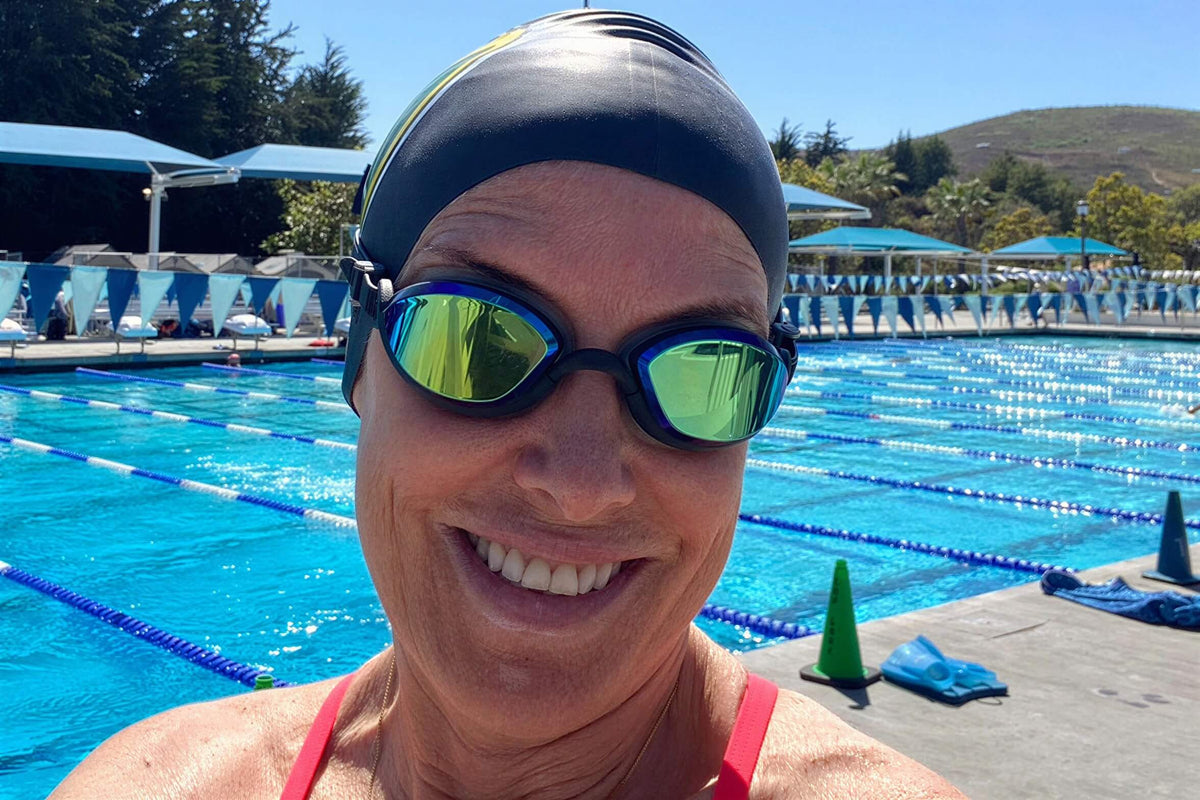 A woman at a pool wearing black, tinted Basilisks from S&P